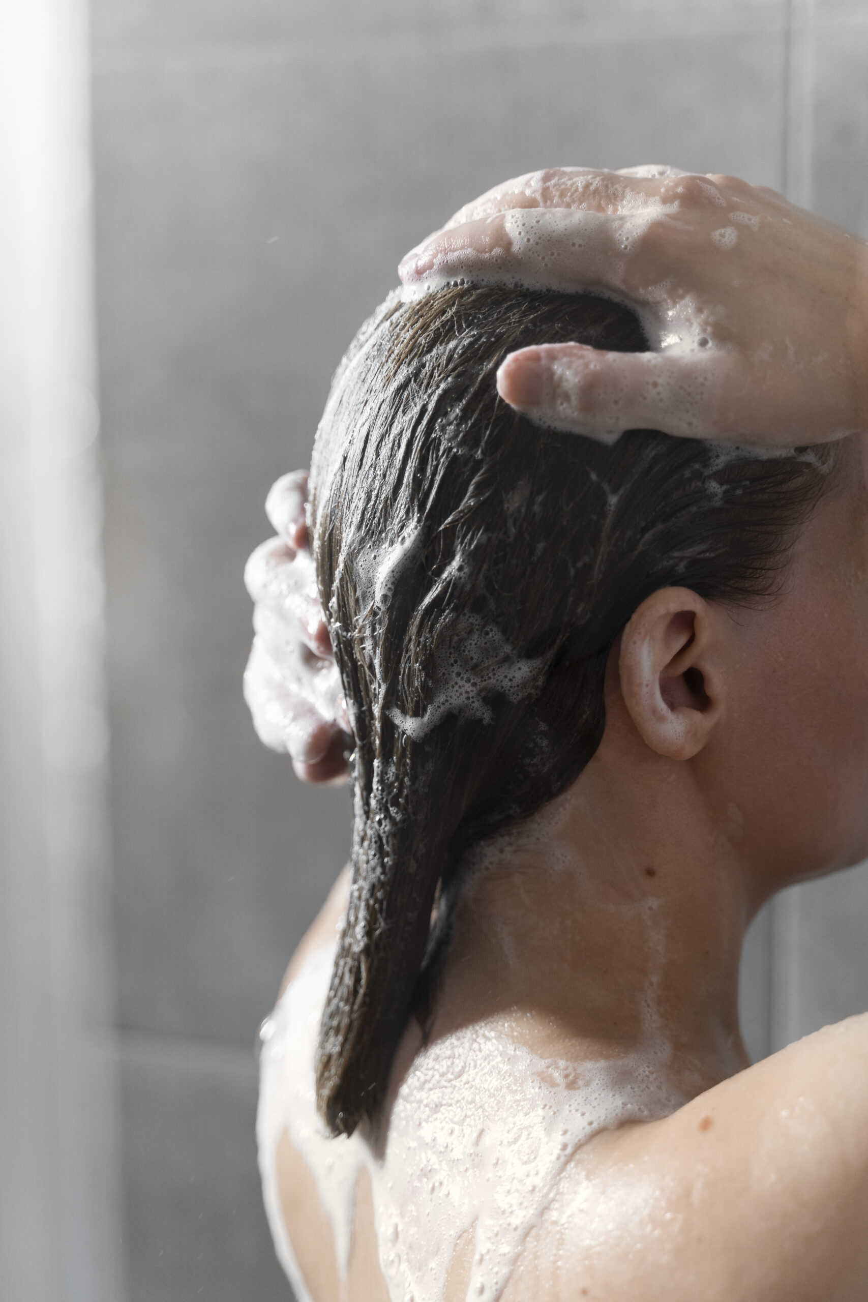 young-woman-applying-anti-dandruff-product (1)